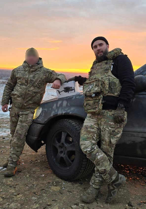 Alex handing over a drone in Donbas